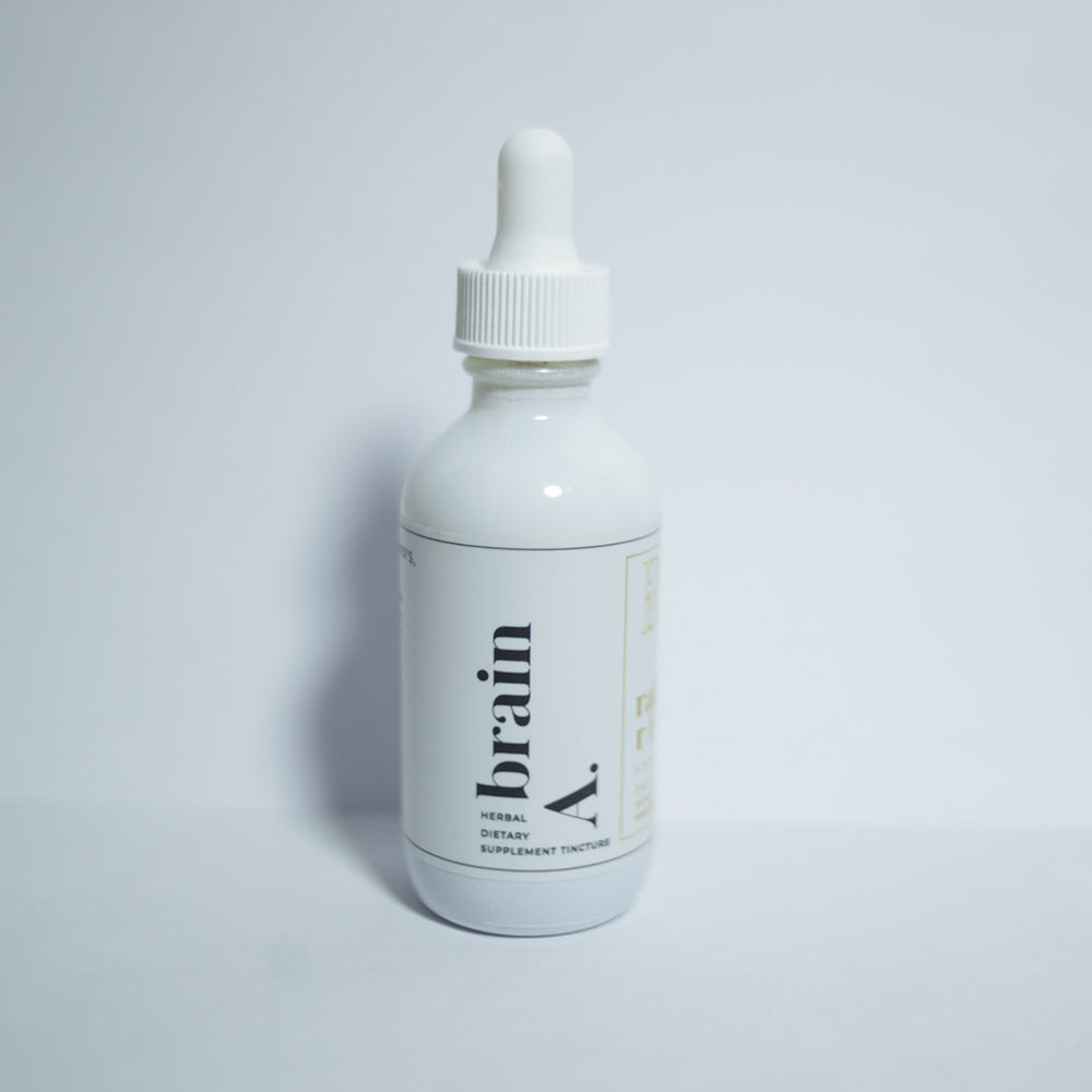 White tincture droplet bottle with a minimal white label with black lower-case serif text saying "brain A." The bottle sits on a bright white background.